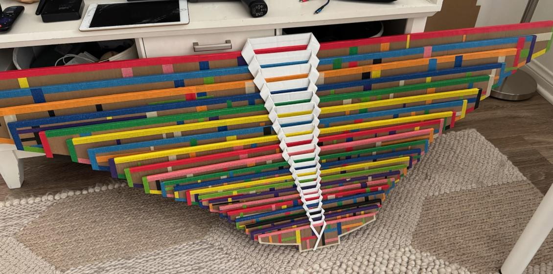 Colorful modular installation work by Hyungjoo Kim in a triangular configuration.
