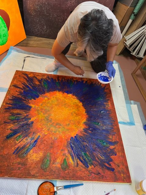 Hyungjoo Kim working on an untitled circular painting in the studio.